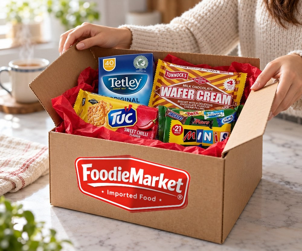 Hands opening a FoodieMarket box of imported snacks